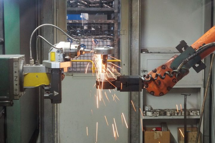 Ramiona robotów przemysłowych pracujące przy linii produkcyjnej w fabryce